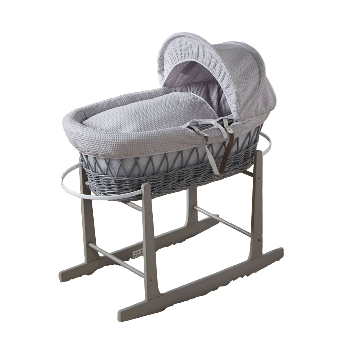 Gray wicker baby Moses basket on a stand in a nursery setting
