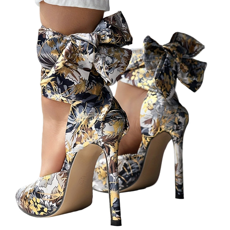 High-heeled shoes with floral patterns and bows on a neutral background