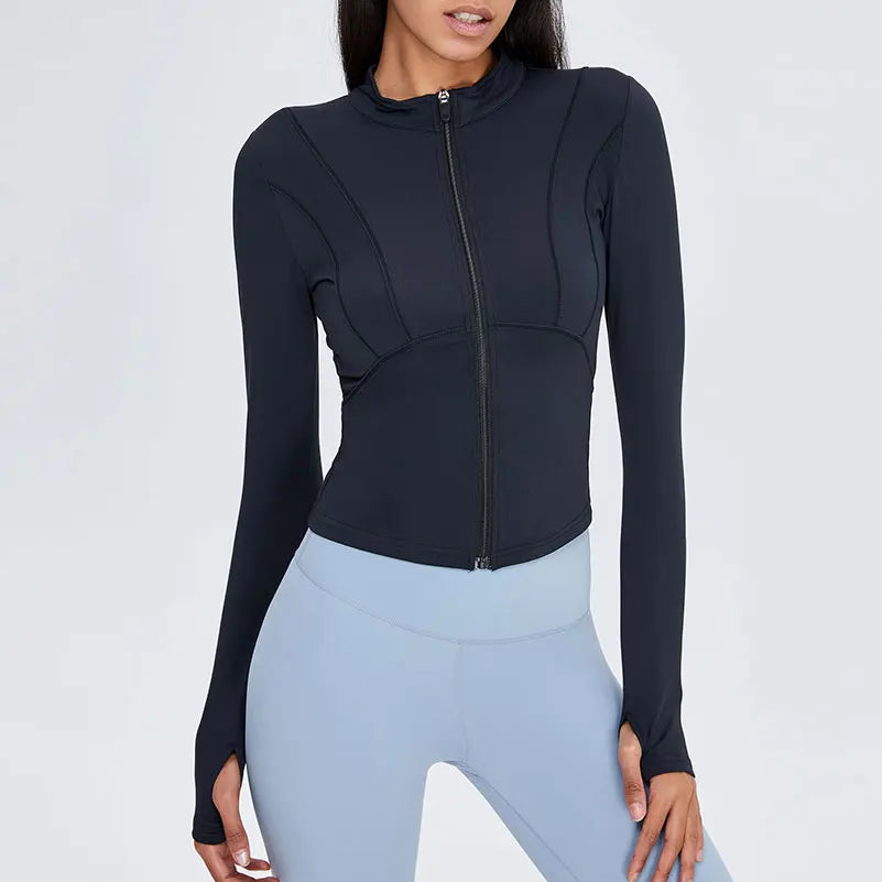 Person wearing a black long-sleeve top and light blue leggings on a white background