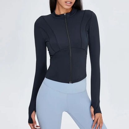 Person wearing a black long-sleeve top and light blue leggings on a white background