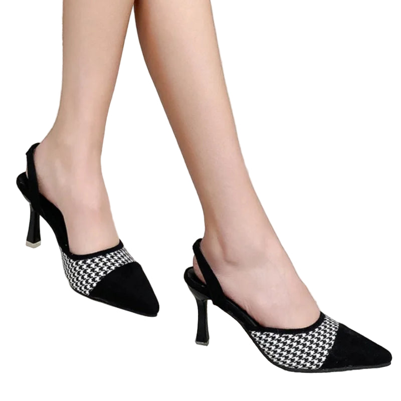 Black and white checkered high-heeled shoes on a neutral background