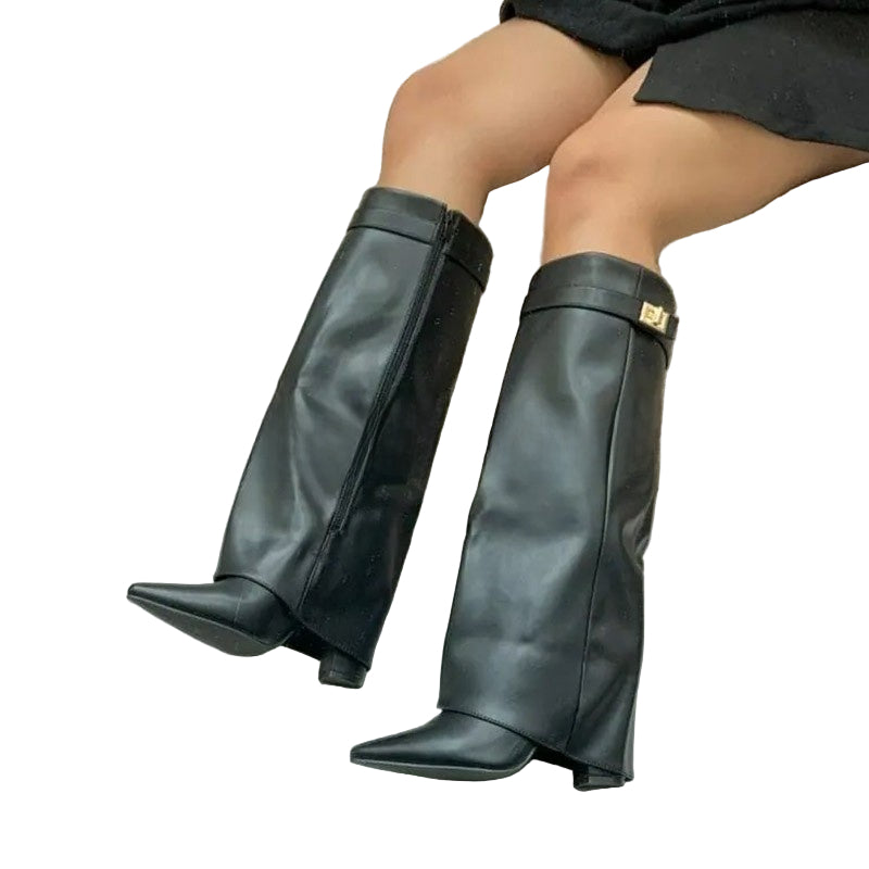Black knee-high boots worn by a person sitting on a chair.
