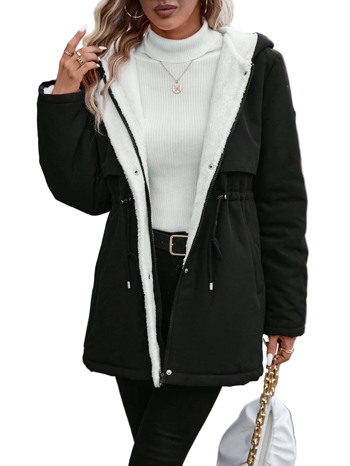 Person wearing a black coat with white lining on a street.