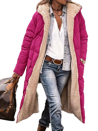Person wearing a pink and beige puffer coat with jeans and a white shirt.